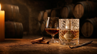 Kilian Angels' Share bottle beside a cognac snifter and cinnamon sticks in a barrel cellar